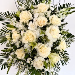 Cream rose bouquet with white filler flowers and palm fronds