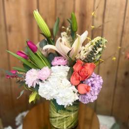 Mixed bouquet with lilies, roses, hydrangeas, and carnations in a vase