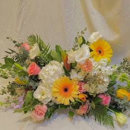 Mixed bouquet with yellow gerbera daisies, pink roses, and white blooms