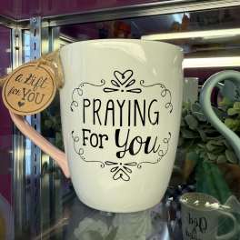 White mug with "Praying for You" text and a hanging gift tag