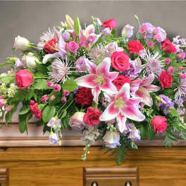 Large pink and lavender floral arrangement with lilies and roses