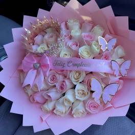 Pink and white rose bouquet with butterfly decorations and a ribbon
