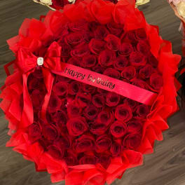 Large bouquet of red roses with a "Happy birthday" ribbon