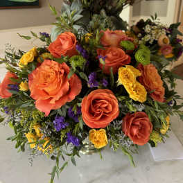 Bright mixed bouquet with orange and yellow roses in a vase