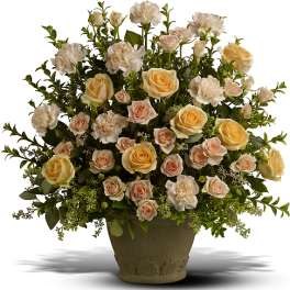 Arrangement of pale roses and carnations in a textured vase