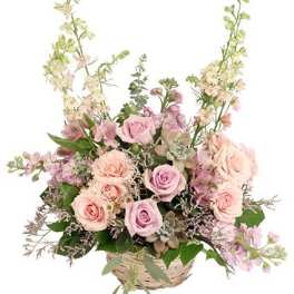 Basket arrangement of pink roses and lavender flowers