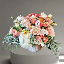 Large bouquet of pink and white roses in a textured vase