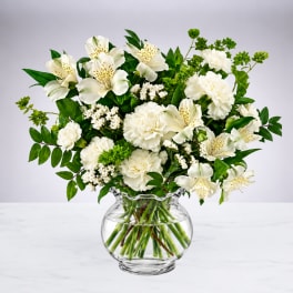 White flowers arranged in a clear glass vase