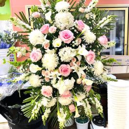 Large standing floral spray with pink roses, white lilies, and white chrysanthemums