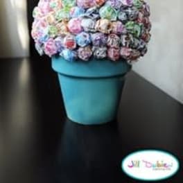 Colorful bouquet of small flowers in a blue pot