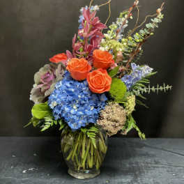 Colorful mixed flower arrangement in a glass vase