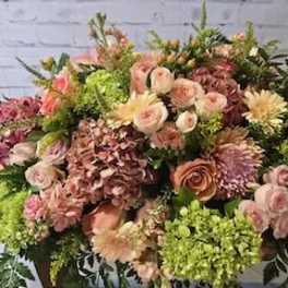 Large mixed bouquet with pink, peach, and green flowers