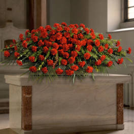 Large red carnation arrangement on a stone pedestal