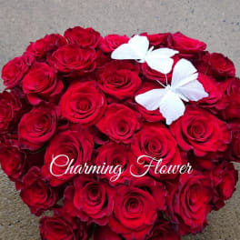 Heart-shaped bouquet of red roses with two white butterflies