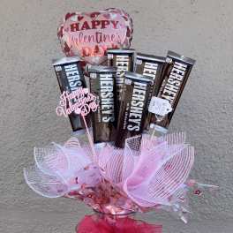 Valentine's Day balloon and Hershey's chocolate gift arrangement in a glass vase