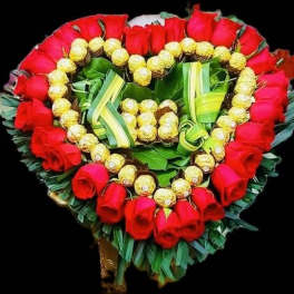 Heart-shaped bouquet of red roses and gold-wrapped chocolates