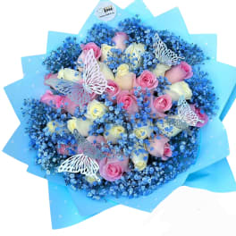 Bouquet of pink and white roses with blue baby's breath and butterfly accents
