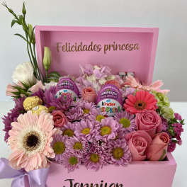 Pink gift box arrangement with roses, daisies, and chocolates