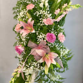 Tall floral standing spray with pink lilies, roses, and carnations