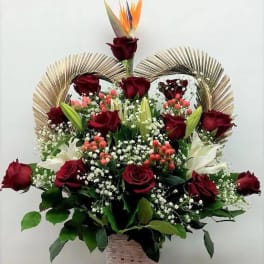 Basket arrangement of red roses, white lilies, and bird of paradise