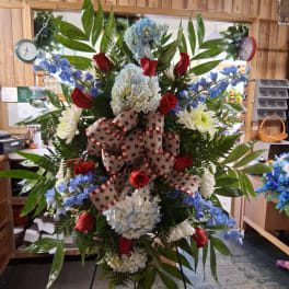 Large patriotic standing floral spray with red, white, and blue flowers