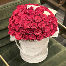 Large bouquet of red roses in a white hatbox with one white rose
