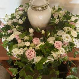 White and pink rose wreath around a ceramic urn