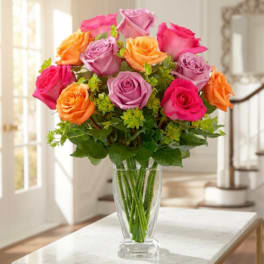 Bouquet of multicolored roses in a clear glass vase