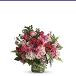 Pink and purple rose bouquet in a glass vase