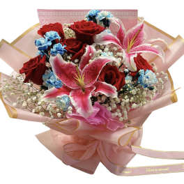 Bouquet of red roses and pink lilies wrapped in pink paper