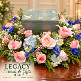 Pink roses and blue hydrangeas surround a decorative keepsake box.