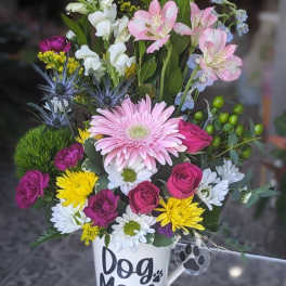 Mixed flower arrangement in a white mug labeled Dog Mom