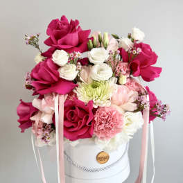 Pink and white rose bouquet in a white hat box with ribbons