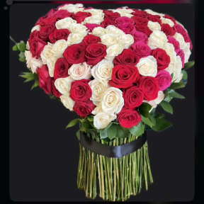 Heart-shaped bouquet of red, white, and pink roses with a black ribbon