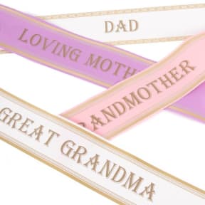 Decorative satin ribbons printed with family titles in pastel colors