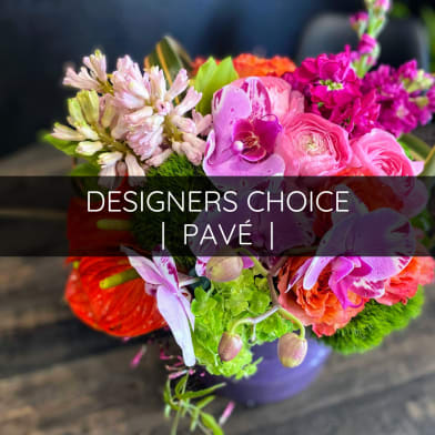 Colorful mixed flower bouquet in a purple vase