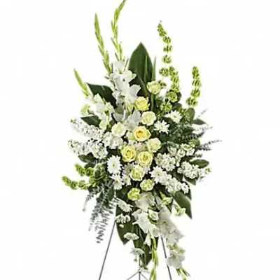 Standing floral spray of white and pale yellow flowers on an easel