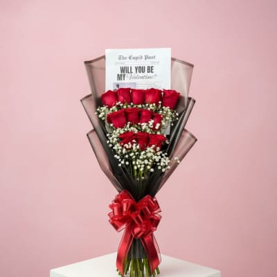 Bouquet of red roses with a Valentine card and red ribbon