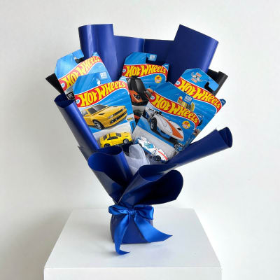 Bouquet of Hot Wheels toy cars in blue wrapping with a ribbon