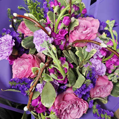 Pink and purple bouquet with roses, carnations, and filler flowers