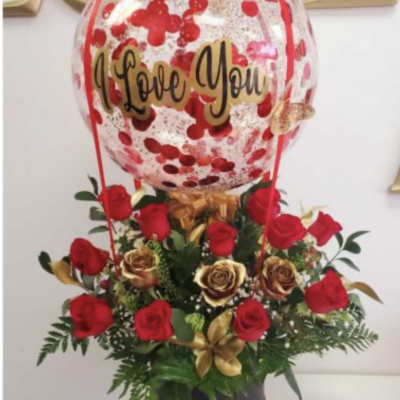 Red rose arrangement with a clear balloon reading I Love You