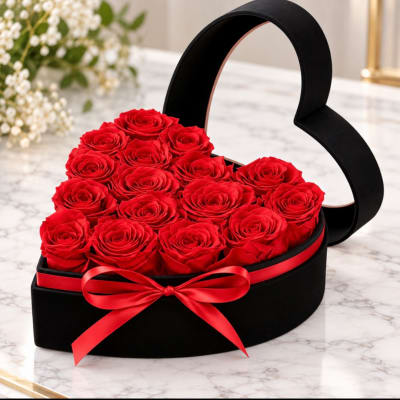 Heart-shaped box of red roses tied with a red ribbon