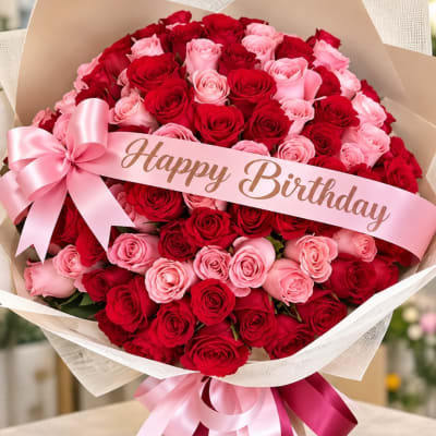 Bouquet of red and pink roses with a pink Happy Birthday ribbon