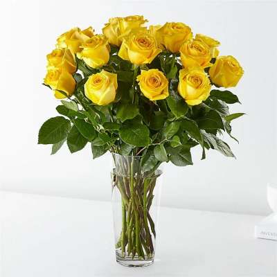 Yellow roses arranged in a clear glass vase