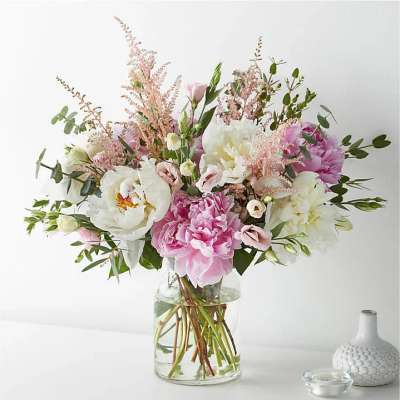 Pink and white bouquet in a clear glass vase