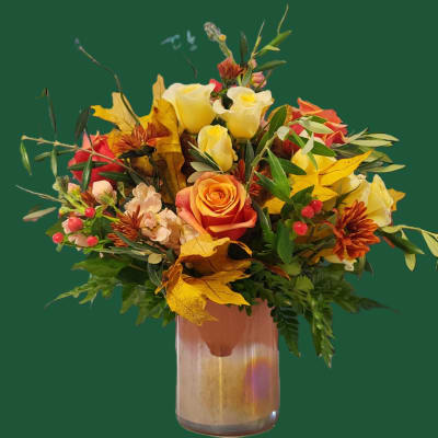 Bouquet of yellow and orange roses in a glass vase