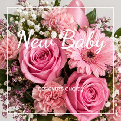 Pink roses and gerbera daisies with carnations in a baby-themed bouquet