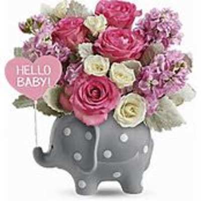 Pink and white flower arrangement in a gray elephant planter with a "Hello Baby!" sign