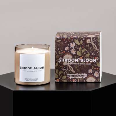 Scented candle in a glass jar beside its floral-patterned box