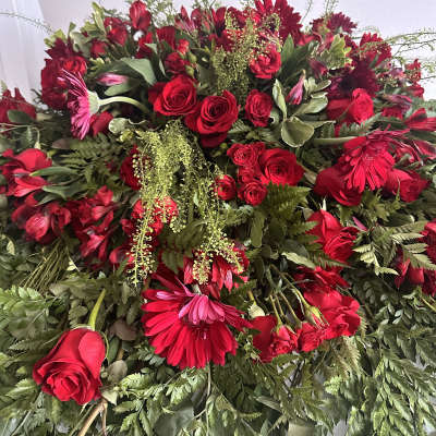 Large red floral spray with roses and gerbera daisies